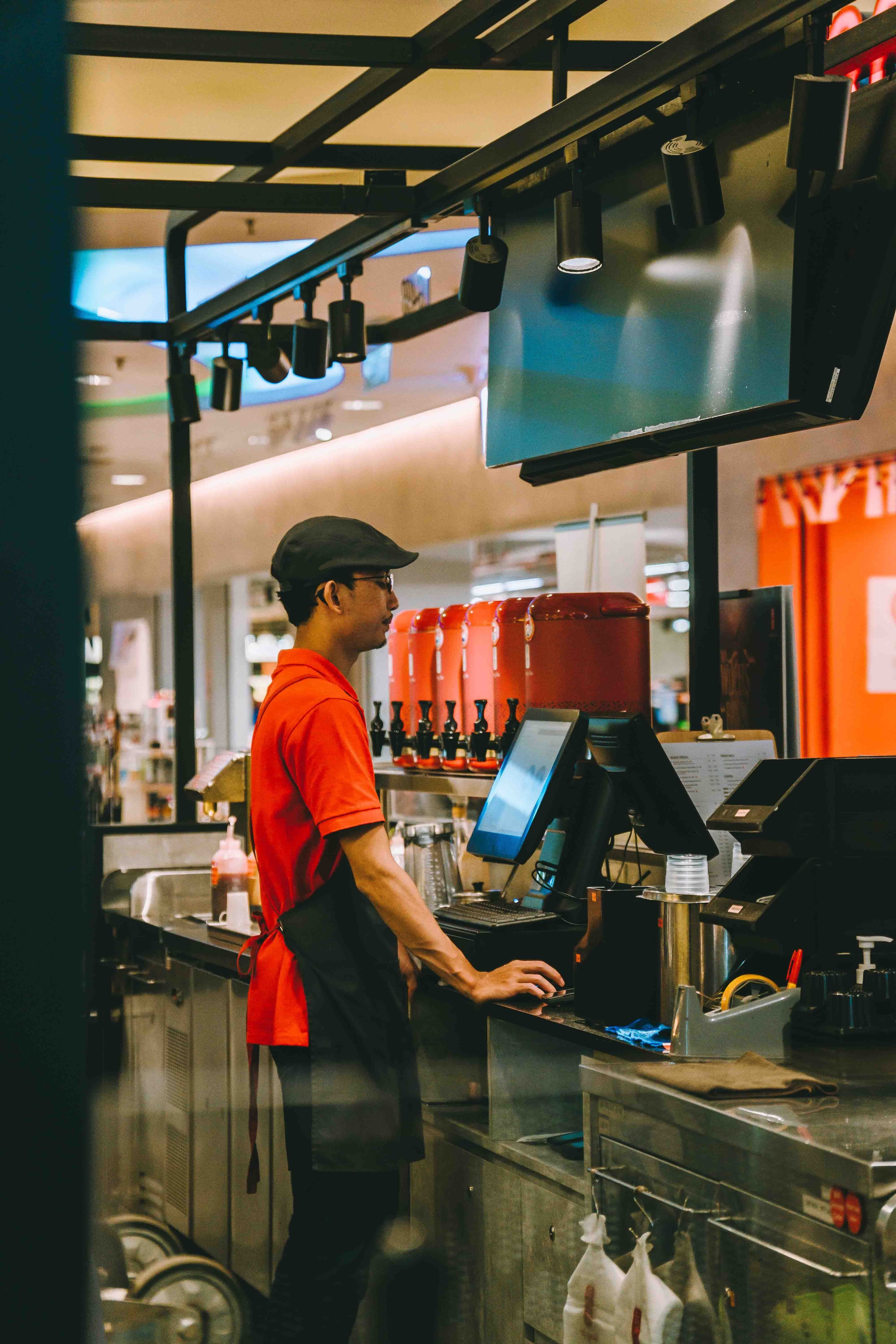 Worker at a beverage counter filling a shift